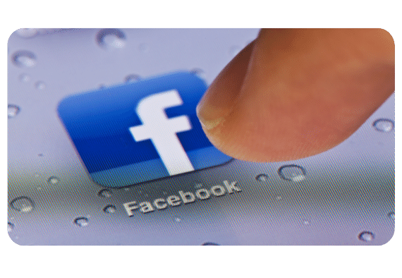 a finger clicking on facebook